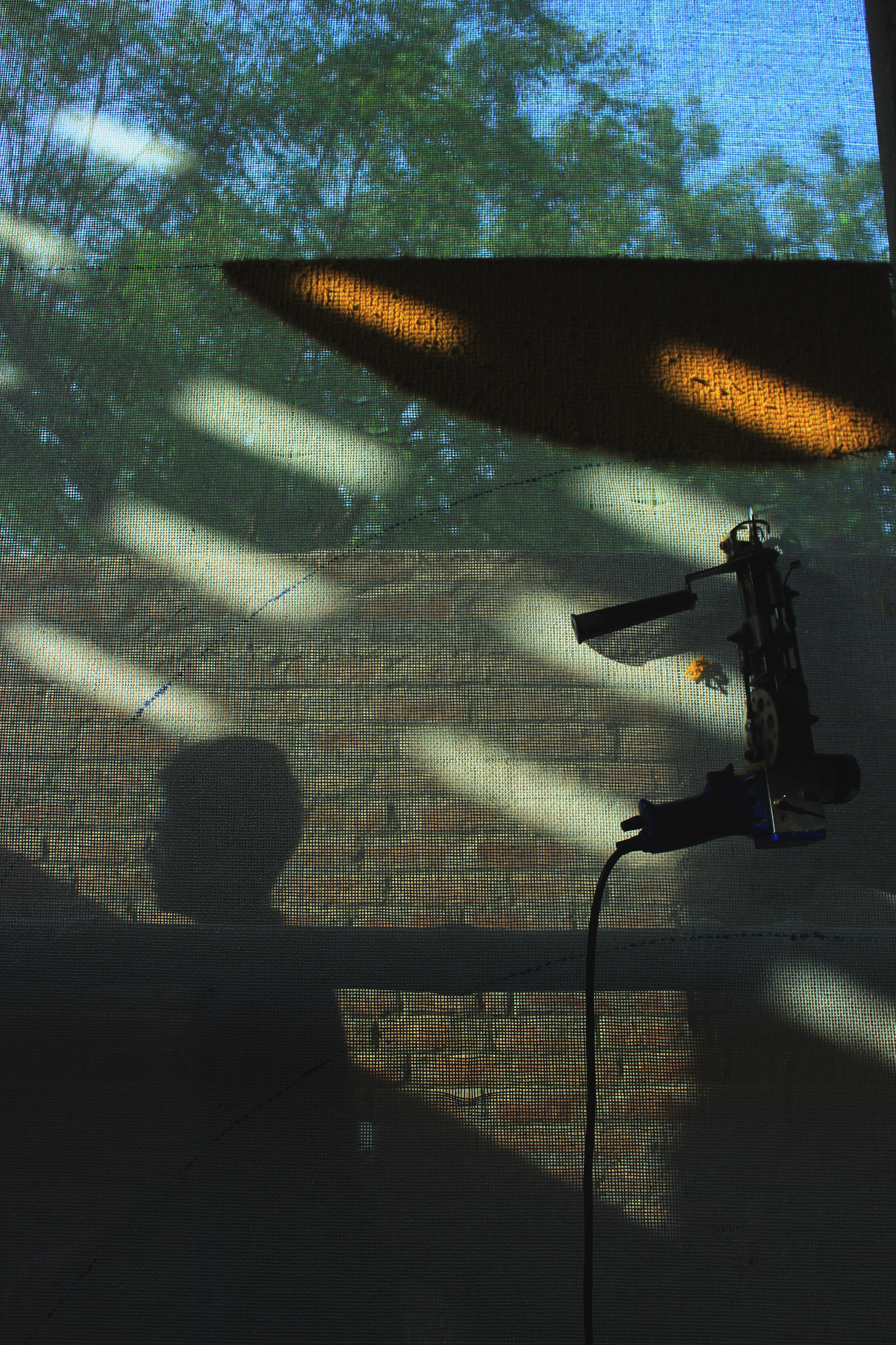 Artisan at the loom with dappled light